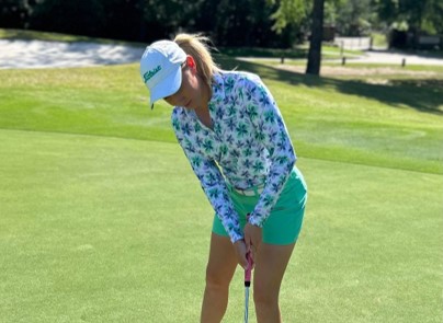 Golf pro Nicole Budnik demonstrates her trendy, modern women's golf apparel style on the golf course.