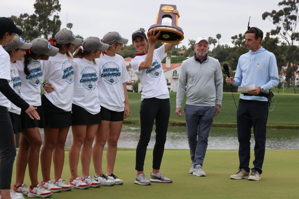 Coach Anne Walker hoists the NCAA Championship trophy up for the second time in three years.