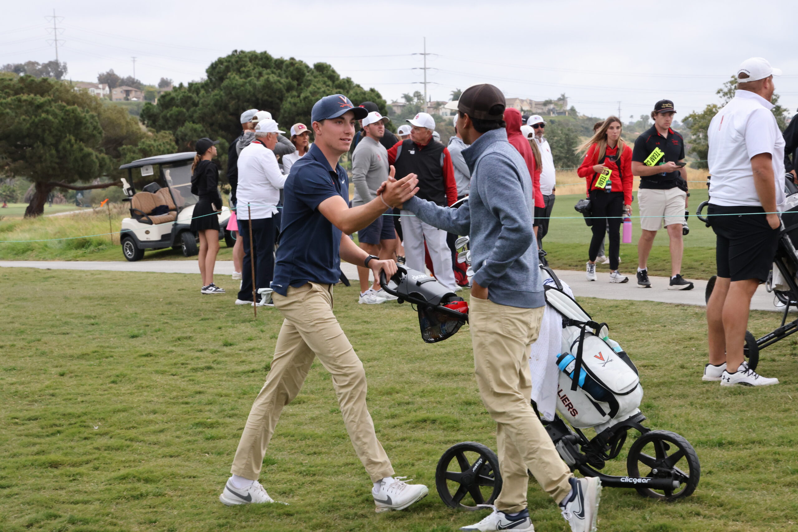 UVA Men's golf teammates congratulate each other on taking the lead at the 2024 NCAA DI Men's Golf Championship.