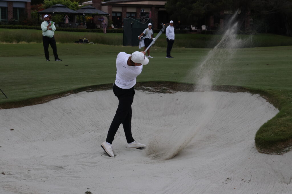 Wallin hits out of the fairway bunker on the second extrahole.