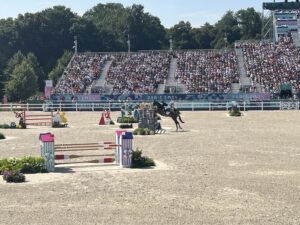 A horse jumps over the Versailles obstacle at the 2024 Paris Olympics Equestrian Eventing Final.