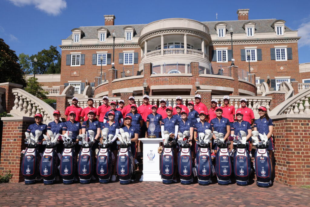 2024 Solheim Cup Team USA poses with their golf bags and caddies.