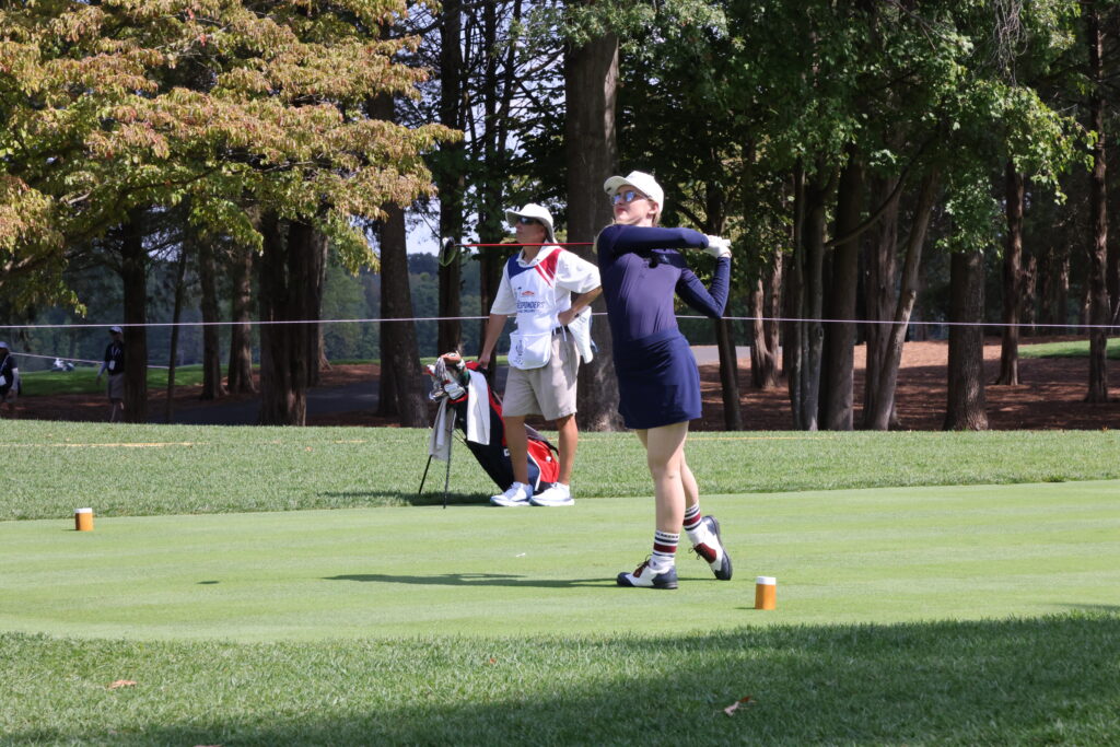 Kathryn Newton tees off to a big crowd during the celebrity-first responder event.