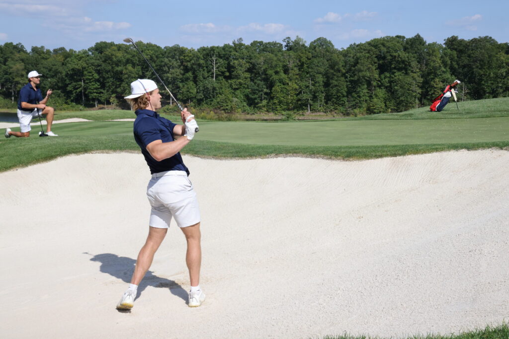 Jakob Chychrun hits a greenside bunker shot on #12 at RTJ.