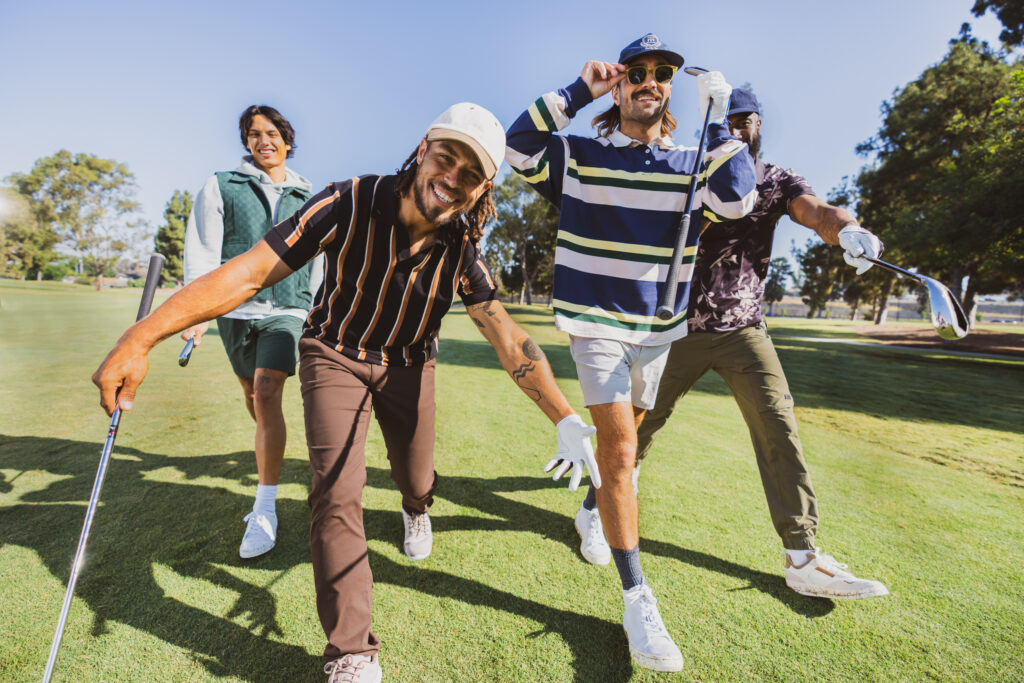 Beginner golfers show off their new Callaway gear from the Topgolf Shop.