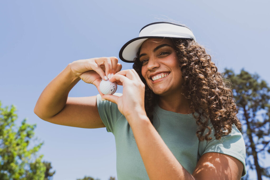 A golfer shows off the splatter-designed Callaway golf ball.