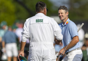 Justin Rose accepts congratulations from his caddie Mark Fulcher on the No. 18 green during the first round of the Masters. Photo courtesy of the Masters and Augusta National.