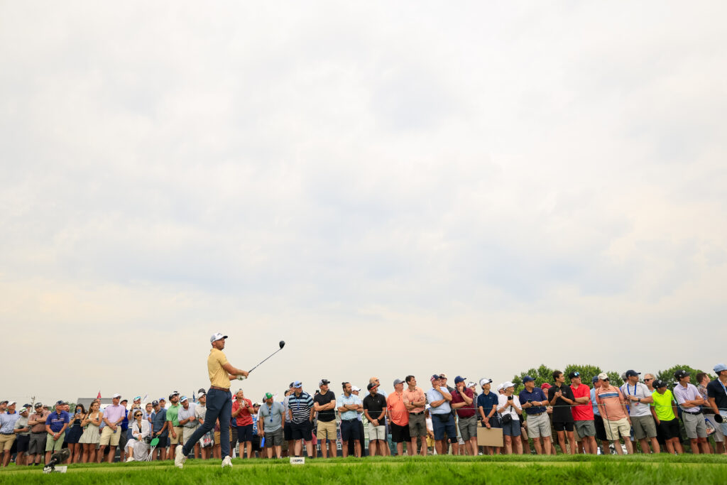 Fans look on as Sam Burns plays his tee shot on the 12th hole during the second round of the 2025 U.S. Open at Oakmont Country Club.