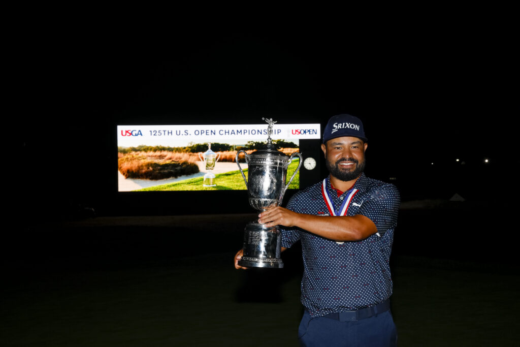 J.J. Spaun holds the U.S. Open Championship trophy during the final round of the 2025 U.S. Open at Oakmont Country Club after a weather delay.