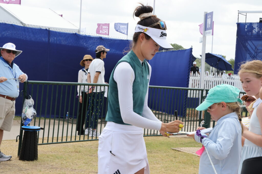 Australia's Grace Kim signs autographs after finishing her third round, today's lowest among all the players.