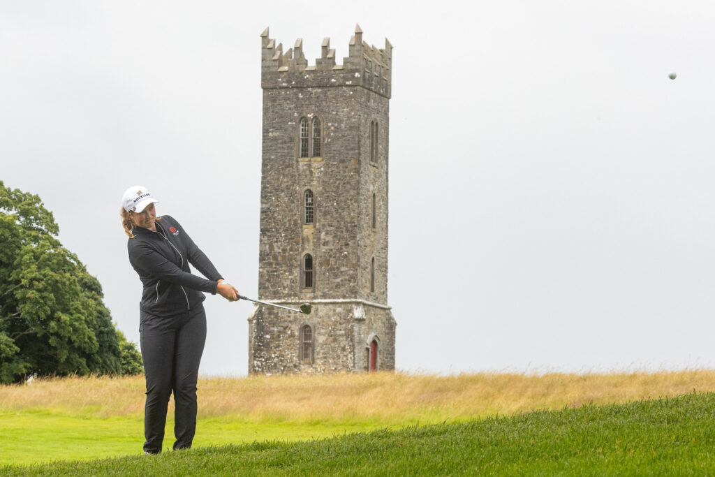 Champion Lottie Woad chipping in front of a castle during the fourth round of the 2025 KPMG Women's Irish Open.