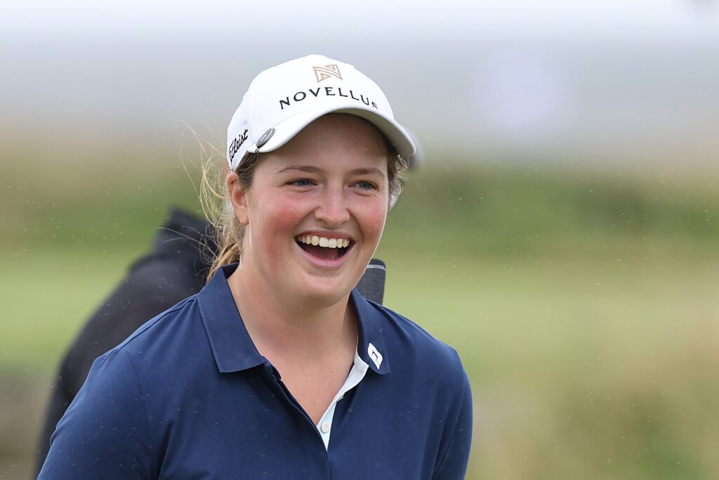 Lottie Woad smiles during a practice round prior to the AIG Women's Open 2025 at Royal Porthcawl Golf Club.