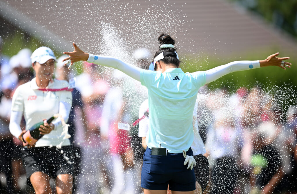 Grace Kim celebrates her first major win as she is sprayed with champagne.