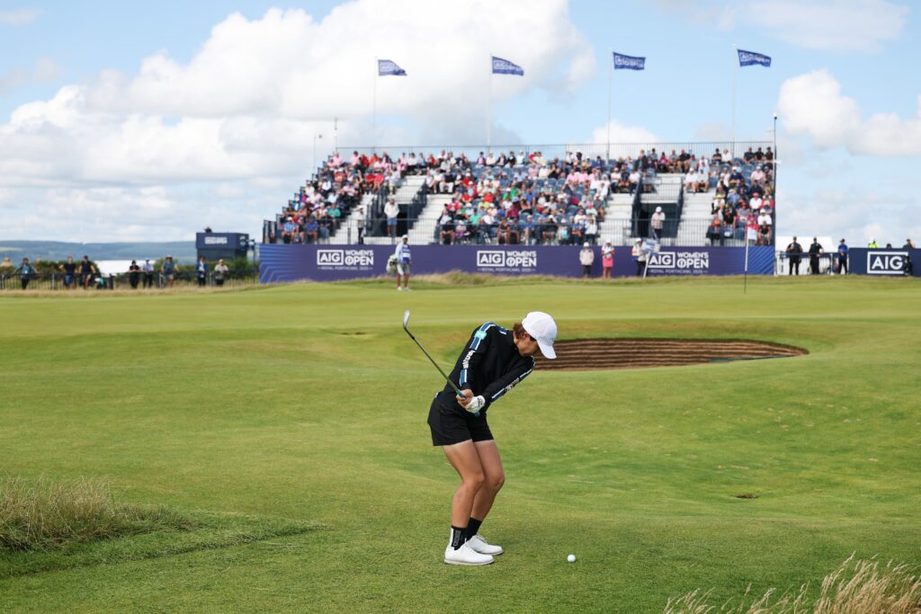 Eri Okayama of Japan pitches onto the 18th green during the first round of the 2025 AIG Women's Open.