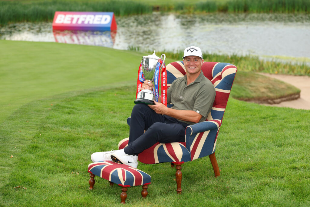 Alex Noren of Sweden poses with the trophy following victory at the Betfred British Masters hosted by Sir Nick Faldo.