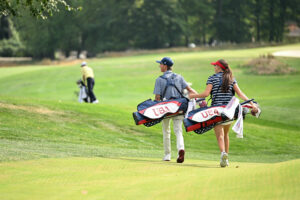 Asterisk Talley and Miles Russell of Team United States walk to the tenth hole during the second round of the 2025 Junior Ryder Cup at Nassau Country Club.
