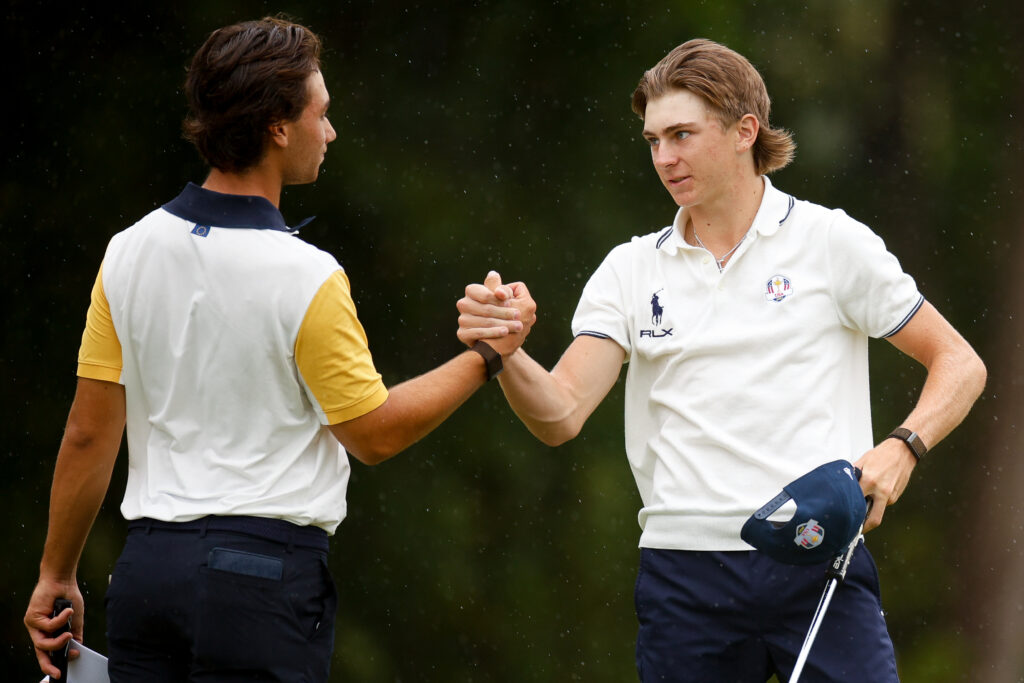 Lunden Esterline of Team United States and Callixte Alzas of Team Europe shake hands after their match on the 16th hole.