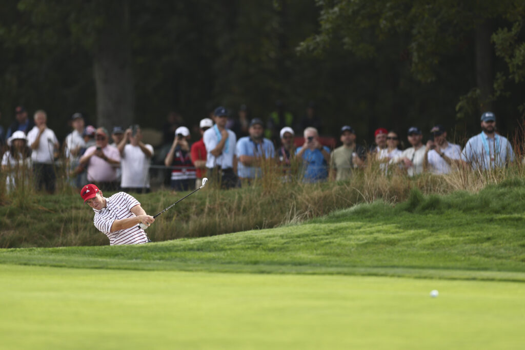 Eli Manning hits his shot on the 13th hole during the All-Star Match.
