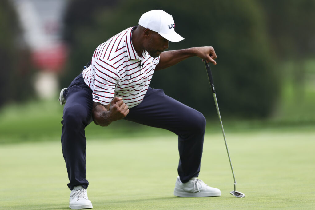 Former NFL Player and television host Michael Strahan reacts to making his putt on the 18th hole on the Black Course.