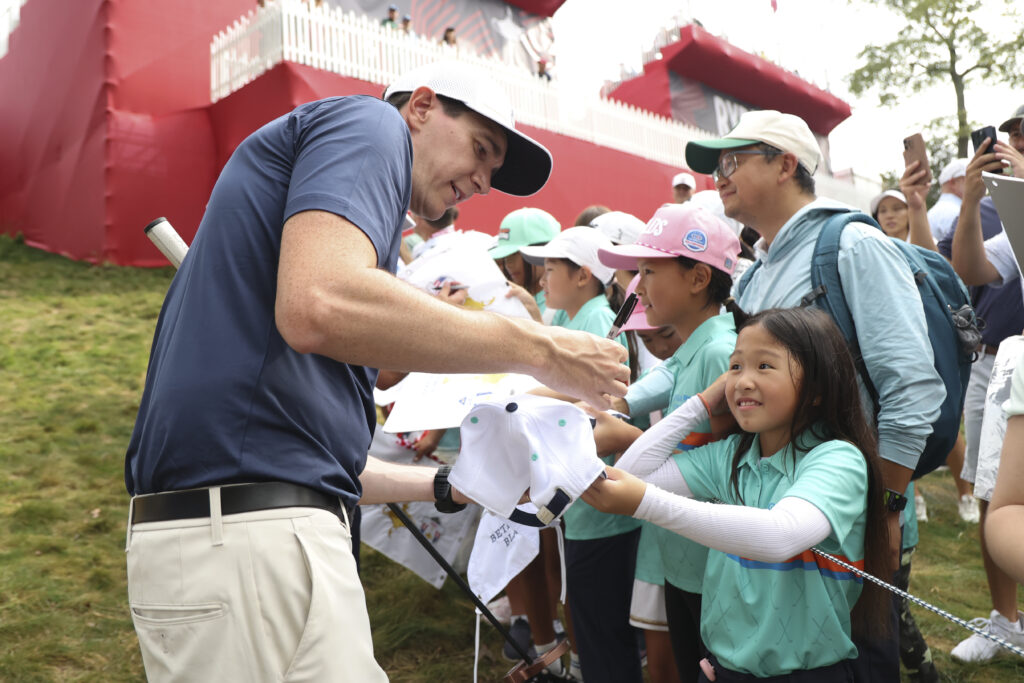 Harry Potter's Oliver Phelps signs autographs for fans during the All-Star Match.