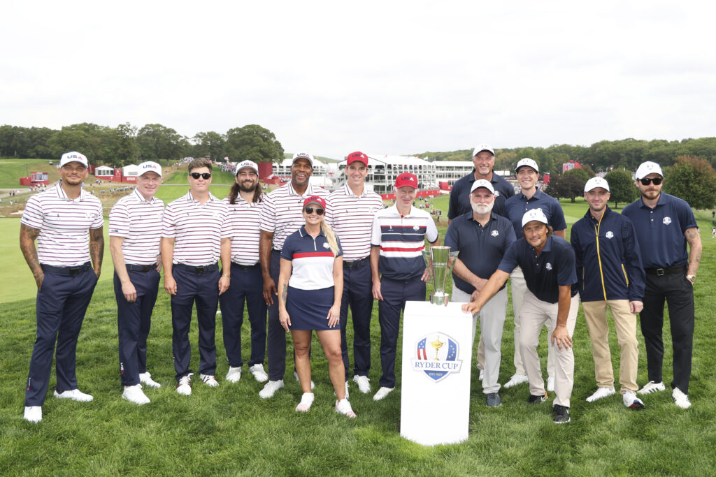 (From left to right) Kane Brown, Bobby Flay, Colin Jost, Noah Kahan, Michael Strahan, Miranda Lambert, Eli Manning, John McEnroe, Toni Kukoc, Jose Andres, Oliver Phelps, Teemu Selanne, Tom Felton, and Brooklyn Beckham pose with the trophy after the All-Star Match.