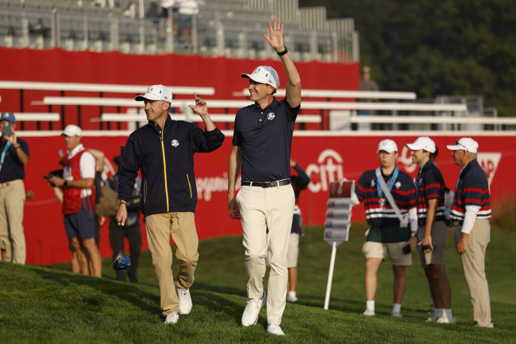 Tom Felton and Oliver Phelps wave during the All-Star Match during the 2025 Ryder Cup.