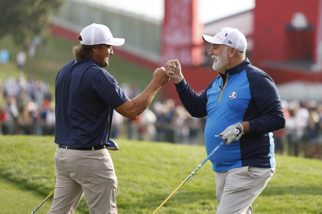 Teemu Selanne and Jose Andres fist bump on the first tee of the Black Course.