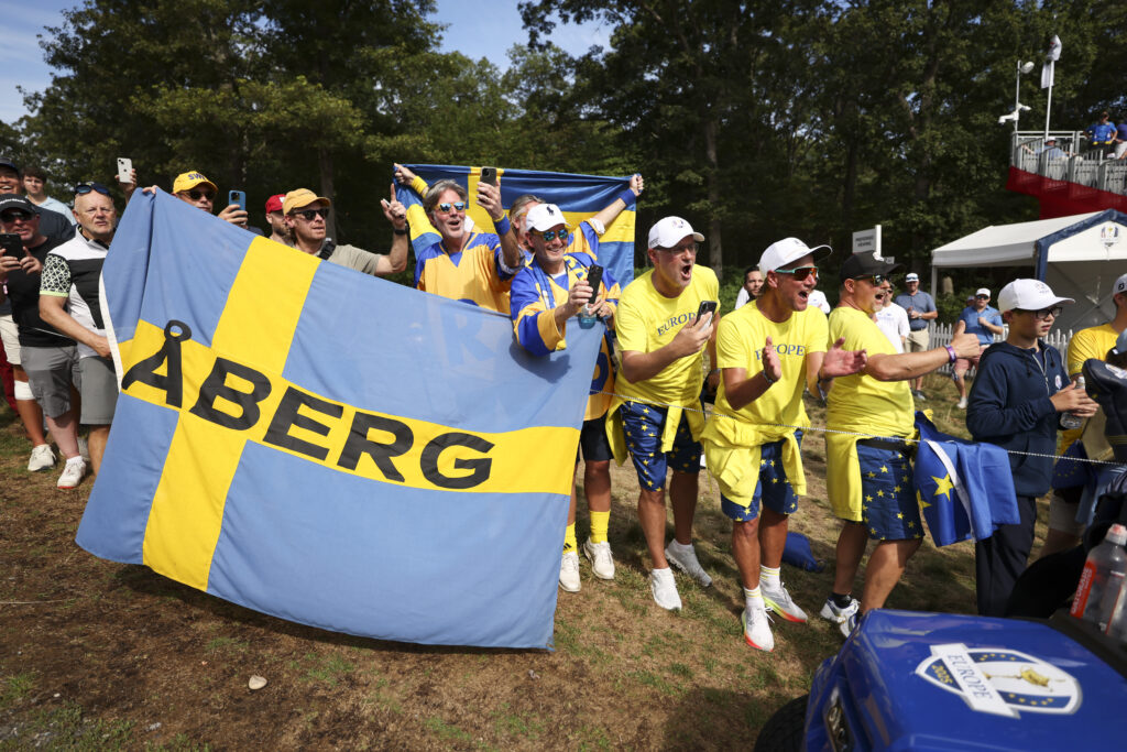 Fans cheer for Ludvig Aberg of Team Europe by the 15th hole of the Black Course at Bethpage.