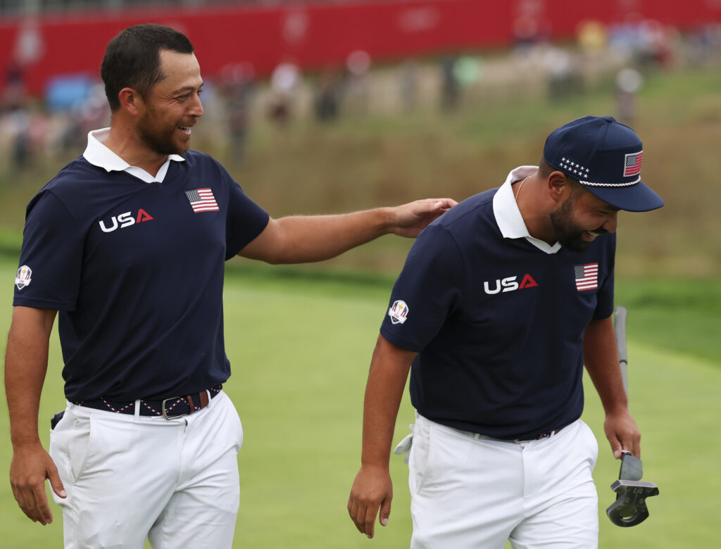 Xander Schauffele and J.J. Spaun of Team United States react on the 18th hole after winning their match.