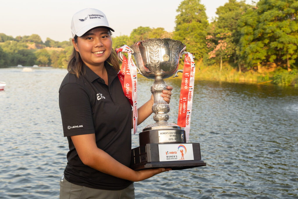 Shannon Tan celebrates her win by posing with the trophy. 