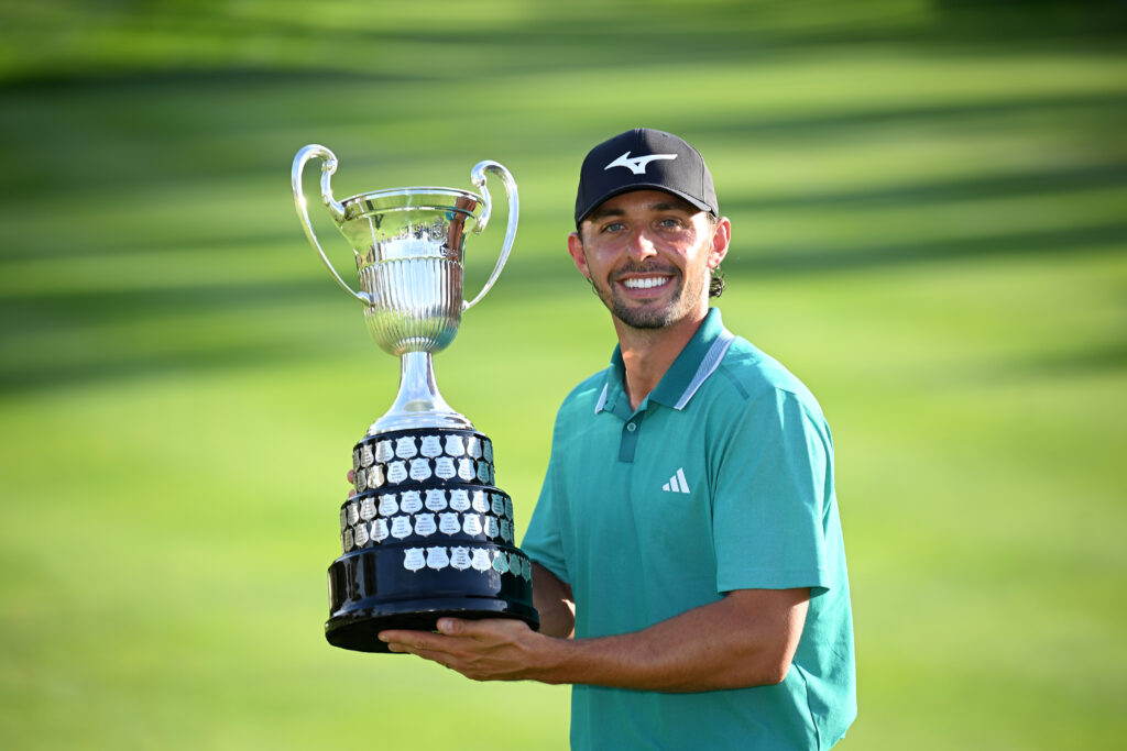 Marco Penge of England is awarded the trophy as he celebrates his playoff victory against Daniel Brown at the 2025 Open de España presented by Madrid.
