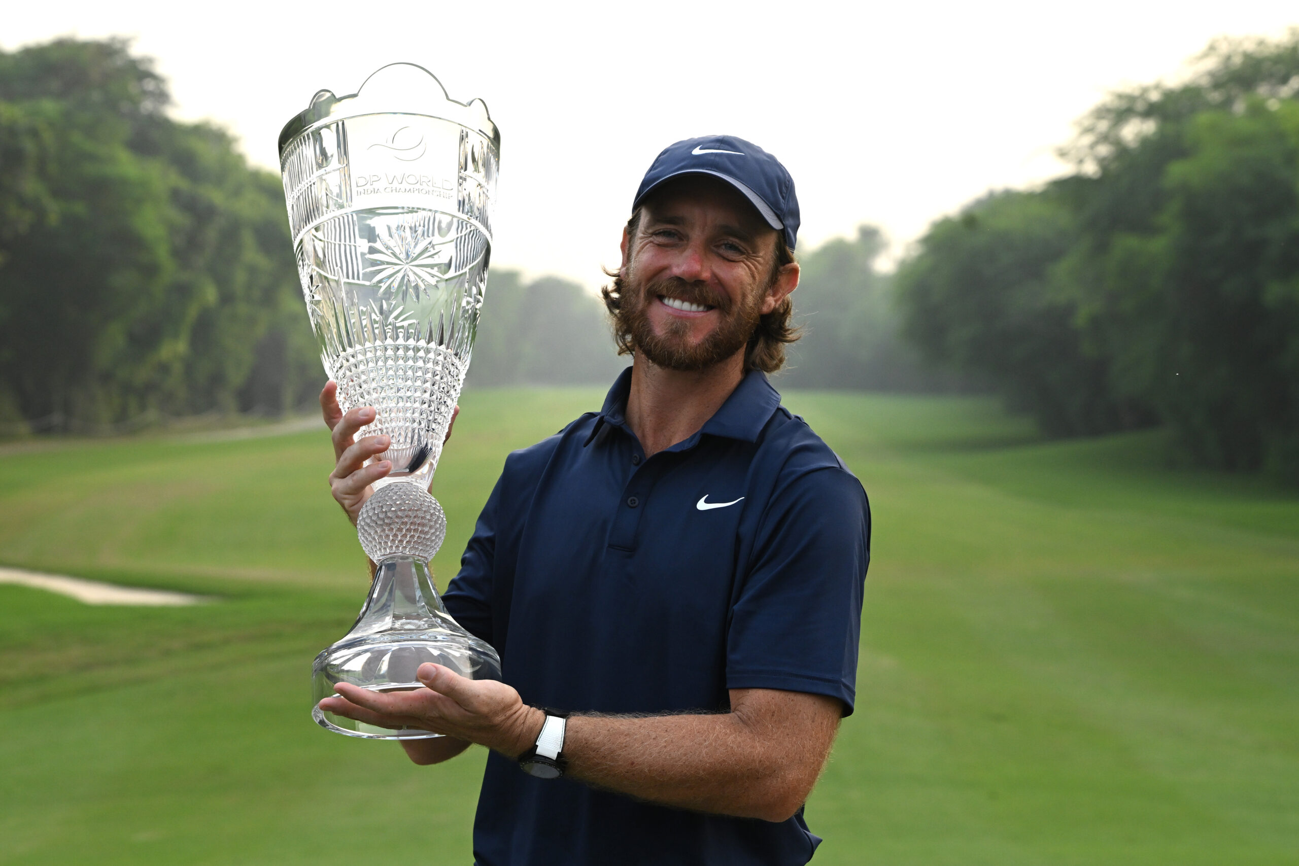 Tommy Fleetwood poses with the trophy following his victory at the 2025 DP World India Championship at Delhi Golf Club.