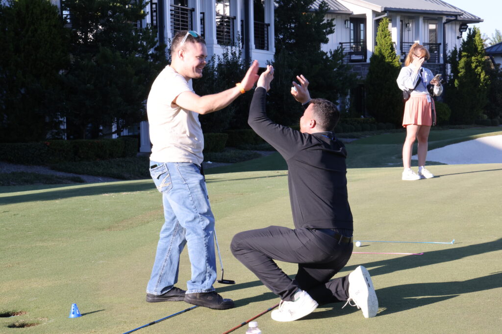 One of the participants celebrates his putt with Gainbridge's Bret Lasky at the I Got This clinic.