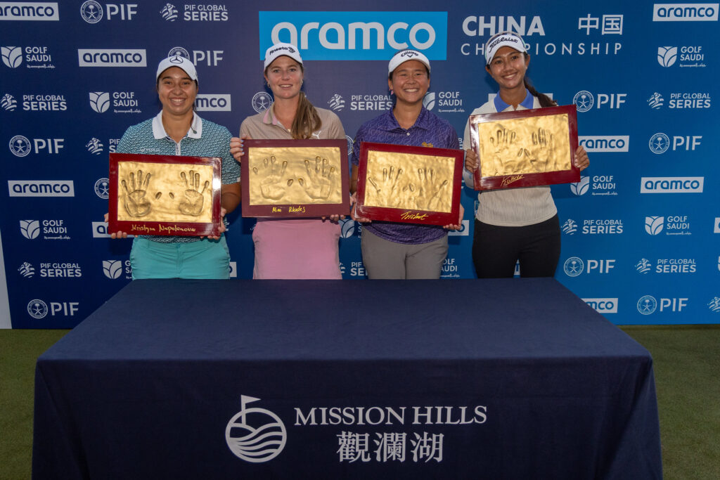 Team Rhodes make their hand prints in clay after winning the team portion of the Aramco China Championship.