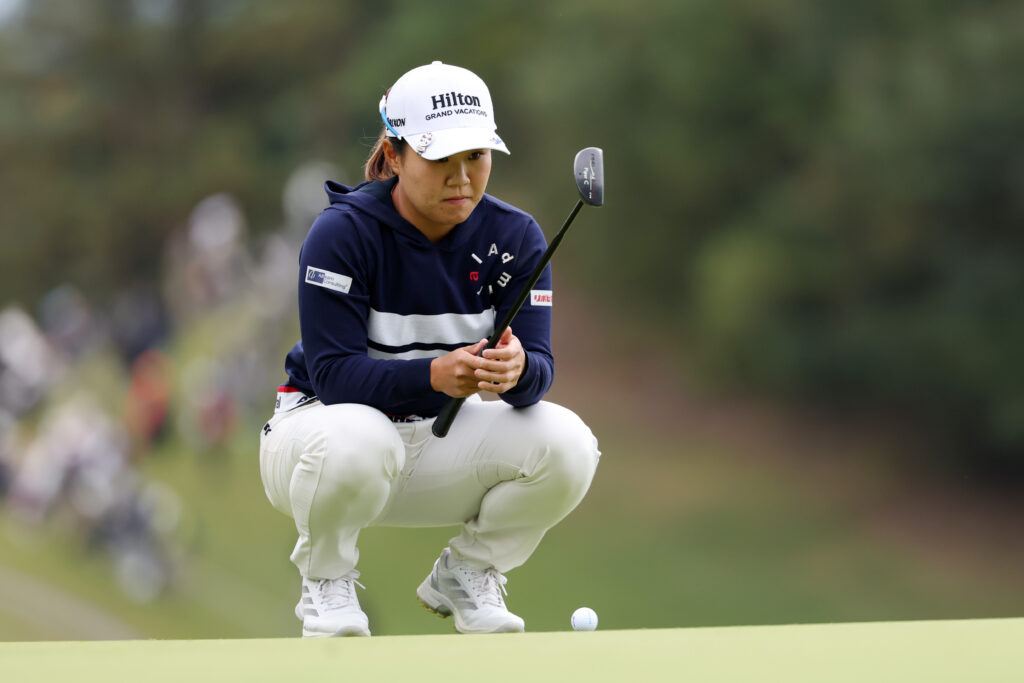 Nasa Hataoka of Japan lines up a putt on the 1st green during the first round of the 2025 TOTO Japan Classic.