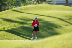 Epson Tour's Juliana Hung checks her yardage book during the first round of the 2025 Epson Tour Championship.