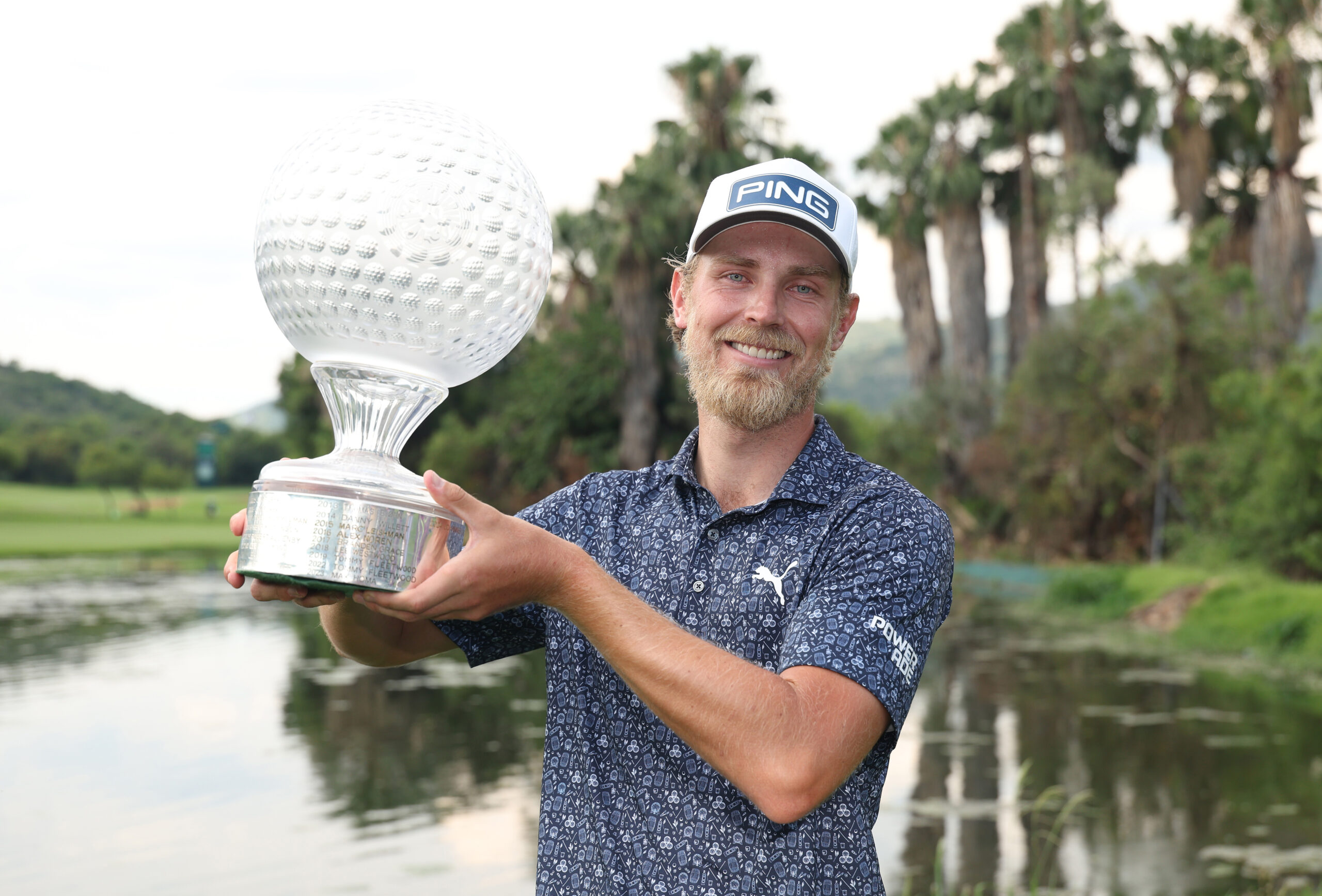 Kristoffer Reitan of Norway poses with the trophy on the 18th green following victory on day four of the 2025 Nedbank Golf Challenge.