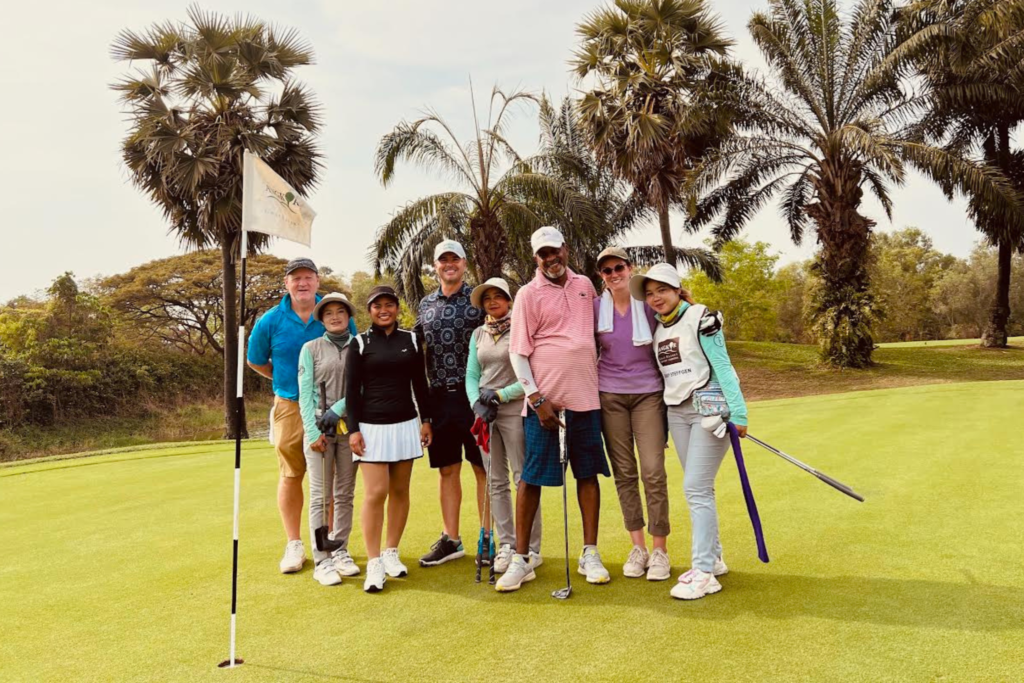 Zanny Merullo surrounded by friends and caddies after her round in Cambodia. 