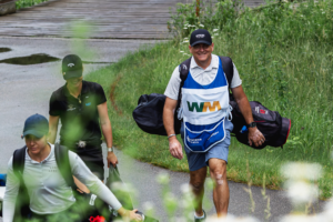 Jody Brothers caddying for Epson Tour player Sophie Hausmann after losing a friendly bet.
