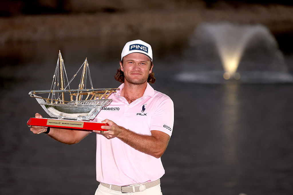 Freddy Schott of Germany poses with the trophy on the 18th green following his playoff victory at the 2026 Bapco Energies Bahrain Championship.