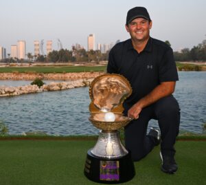 Patrick Reed hoists his second trophy this season.