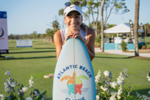 Isabella Fierro poses with the Atlantic Beach Classic surfboard after her win.