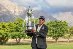 Casey Jarvis hoists the trophy after the final round of the 2026 Investec South African Open Championship at Stellenbosch Golf Club.