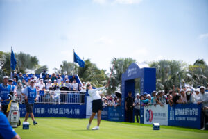 Mi Hyang Lee tees off during the third round of the 2026 Blue Bay LPGA amidst a large crowd.