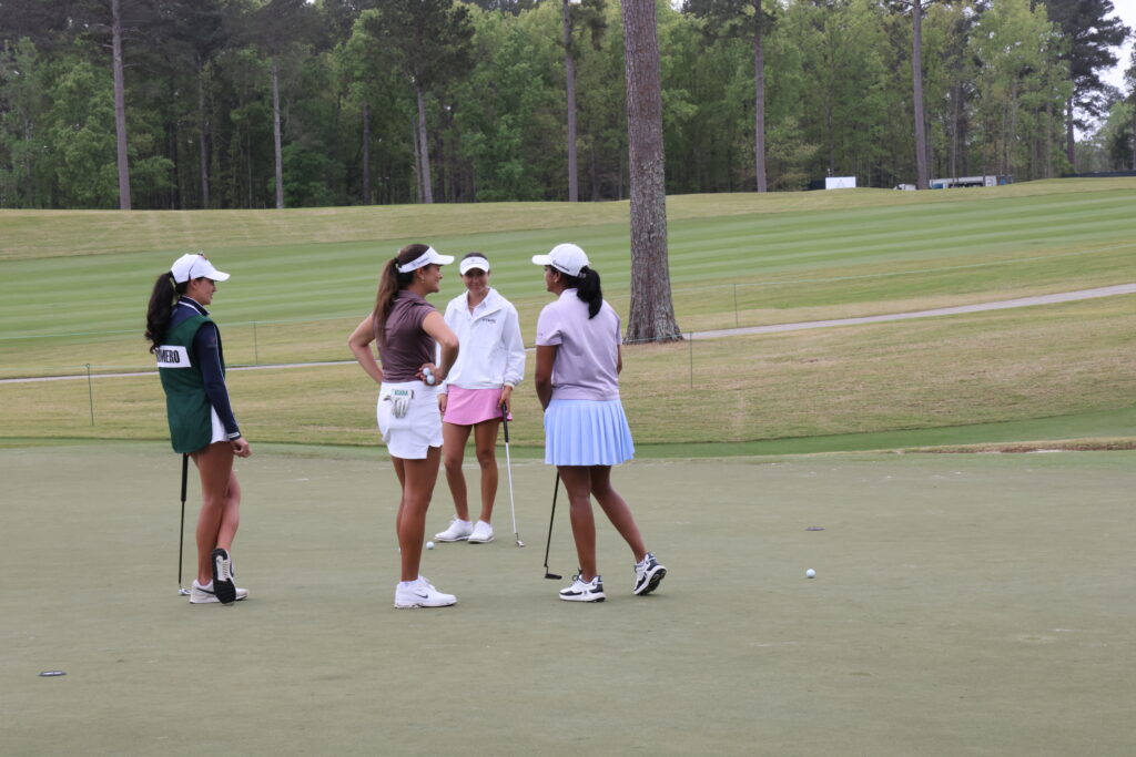Three of the top amateurs in the field - Kiara Romero, Megha Ganne and 2022 champion Anna Davis, chat on the 10th green.