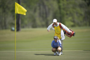 Current co-leader Maria Jose Marin of Colombia reads the ninth green with her caddie at Champions Retreat.