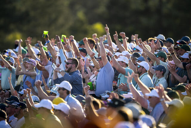 Patrons cheering after Rory McIlroy chipped in for birdie on hole 17 during the second round of the 2026 Masters.