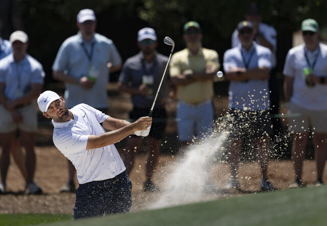Scottie Scheffler plays from a bunker during the final round of the 2026 Masters.