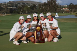 The Stanford Women's Golf Team hoists the 2026 NCAA Division 1 Women's Golf Championship trophy.