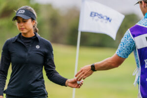 Last year's champion Yana Wilson grabs her ball to head to the next tee.